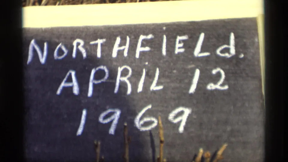Close 8mm view of the handwritten Northfield, April 12, 1969 chalkboard title card, with a pale top strip and dark side border.