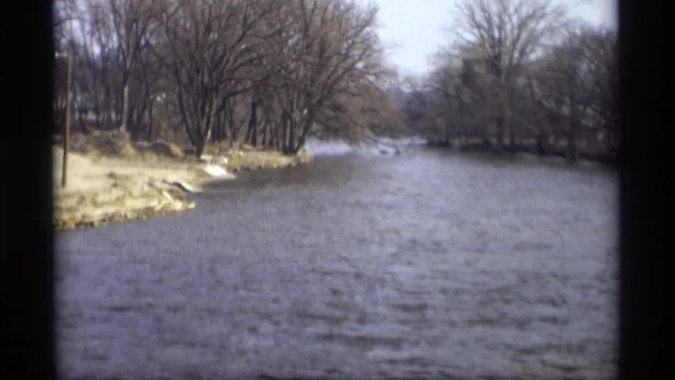 Savage, Minnesota river landscape on 8mm film, with rippling water and bare trees along the bank.