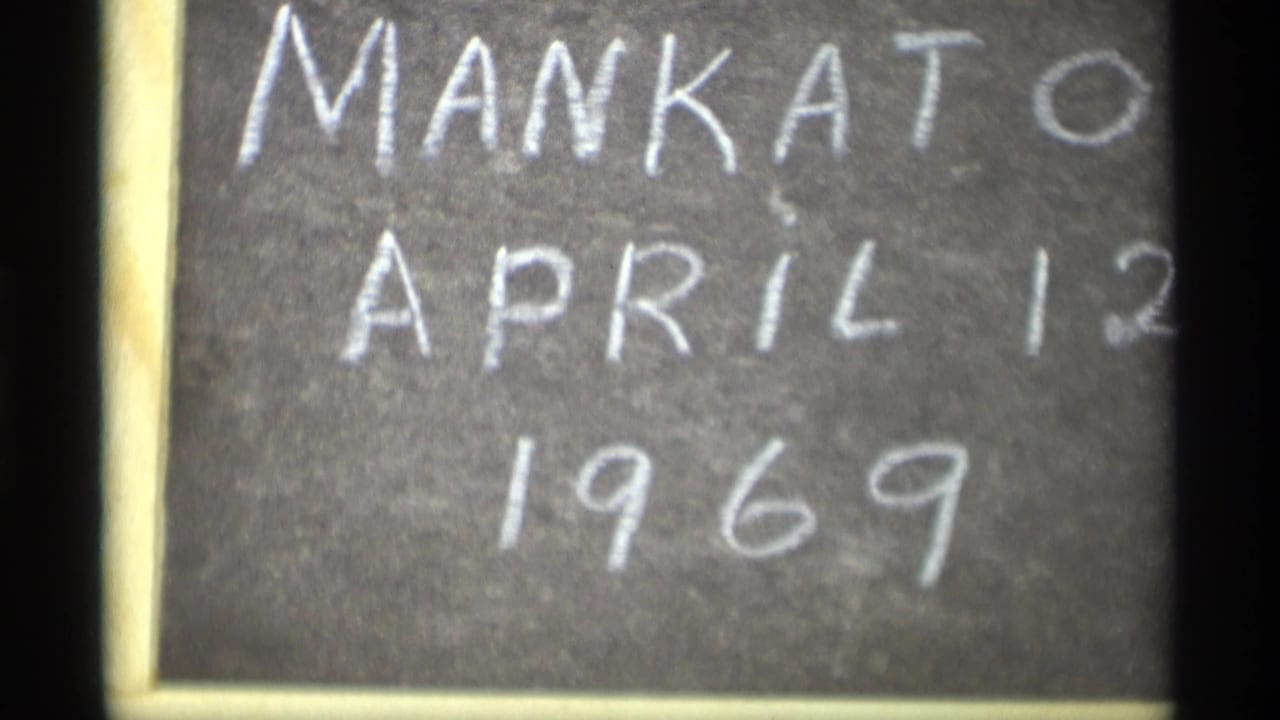 Close view of a handwritten chalkboard sign reading Mankato April 12 1969 on 8mm film.