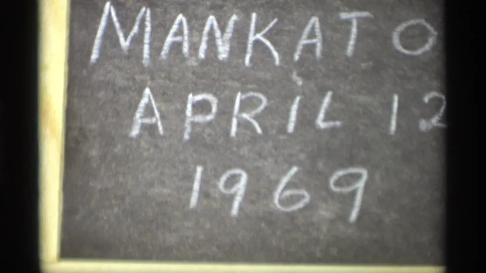 Close view of a handwritten chalkboard sign reading Mankato April 12 1969 on 8mm film.