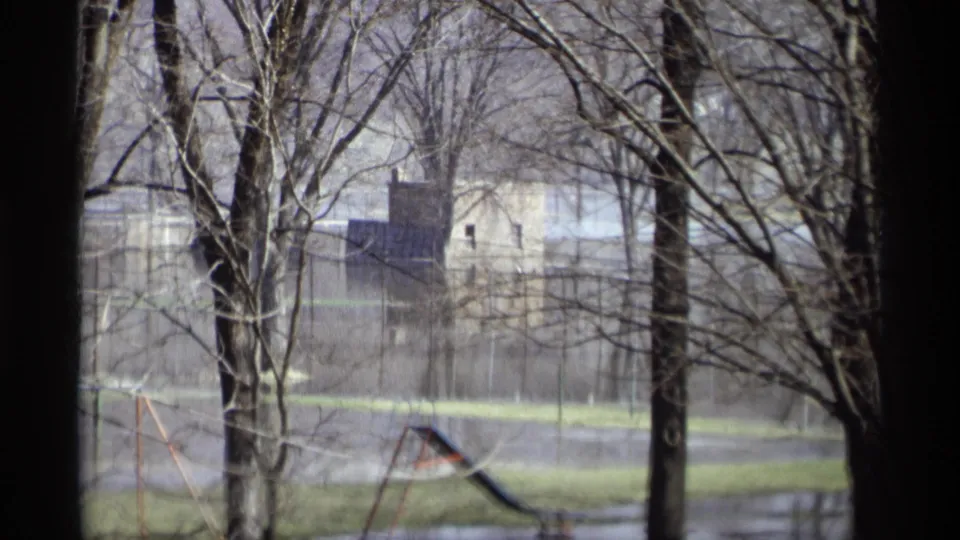 Flooded recreation area in Savage, Minnesota, with bare trees, standing water, playground equipment, and a distant structure.