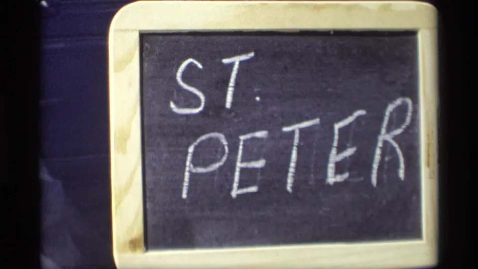 Second 8mm view of the handwritten ST. PETER chalkboard title card against a dark background.
