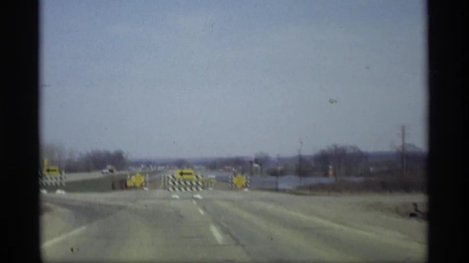 Savage, Minnesota roadway in 1969 with yellow arrow and detour signs marking a flooded or closed section ahead.