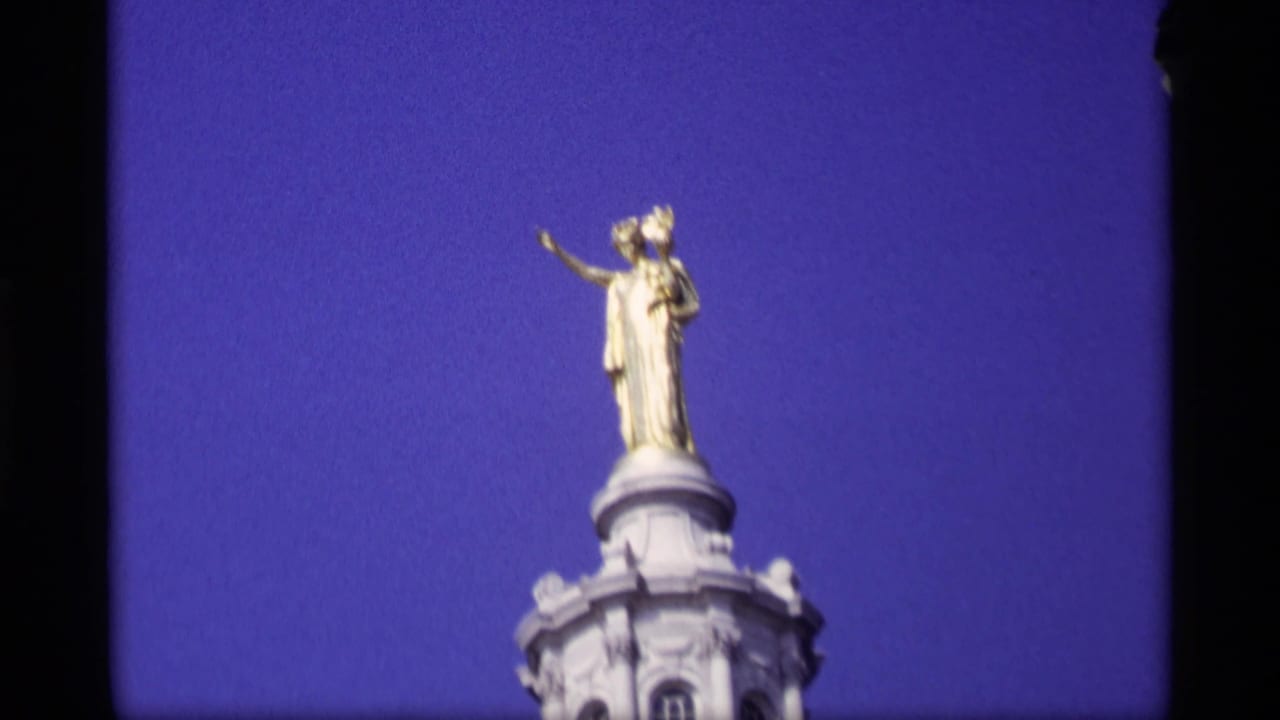 Gold statue above the Capitol dome against a deep blue sky.