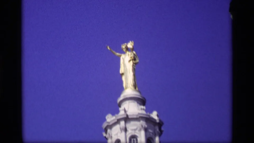 Gold statue atop the Wisconsin State Capitol dome, filmed close from below on 8mm in 1969.