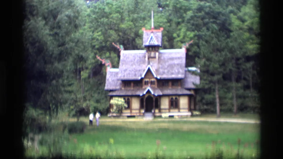 A 1969 Wisconsin 8mm frame shows the wooded landmark from farther back, with visitors small in the lower left of the clearing.