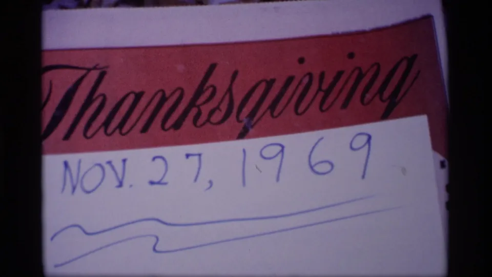 Another close frame of the 1969 Thanksgiving card, showing the handwritten date and blue ink marks under the red banner.