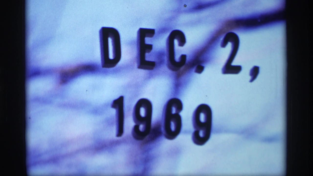 Close-up date card reading Dec. 2, 1969 over a blue-purple snowy background.