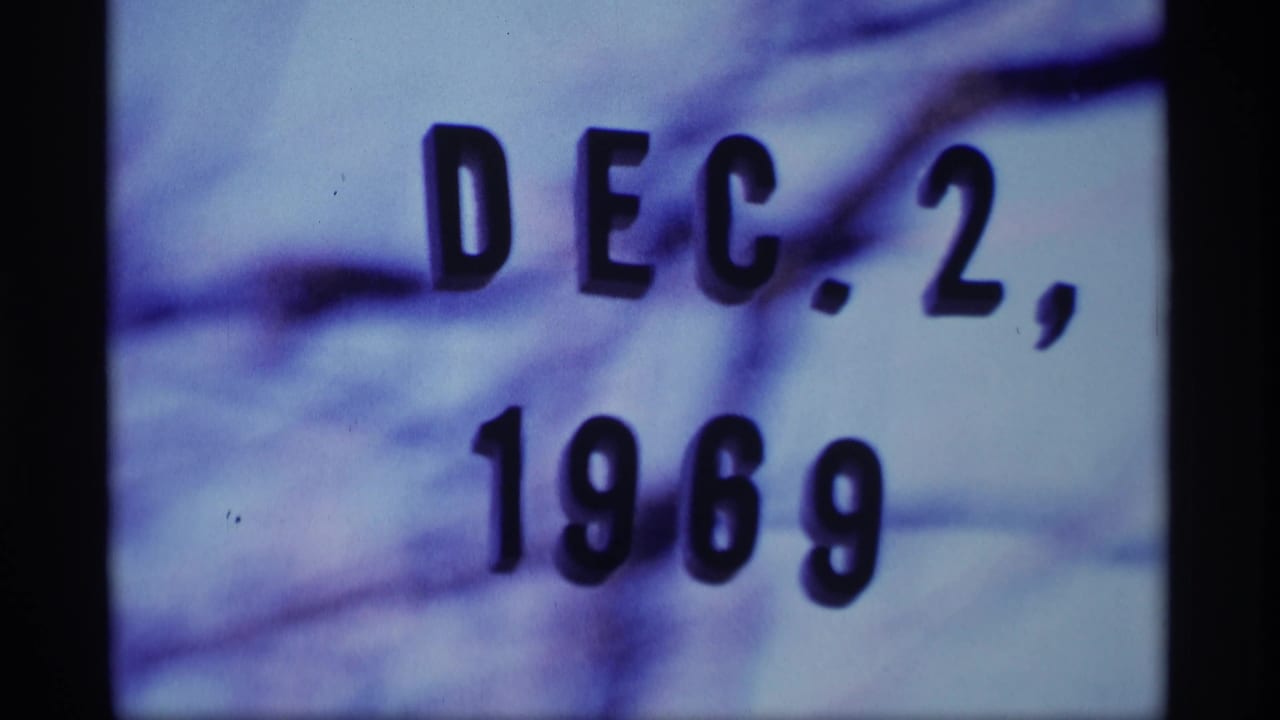 Date card reading Dec. 2, 1969 with soft focus and dark film border at the side.