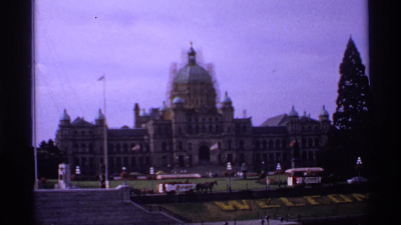 Domed civic building seen from across water or grounds on a soft 8mm frame.