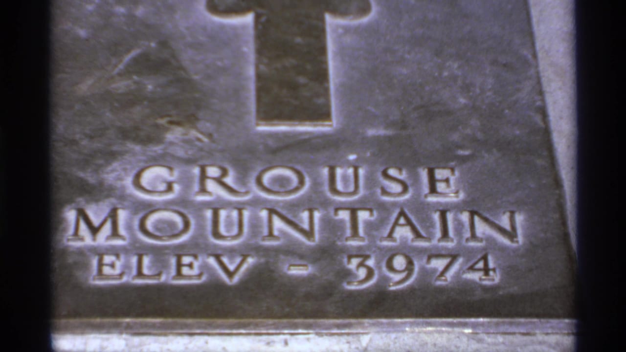 1974 Canada 8mm frame showing a weathered Grouse Mountain elevation marker inscribed ELEV - 3974.