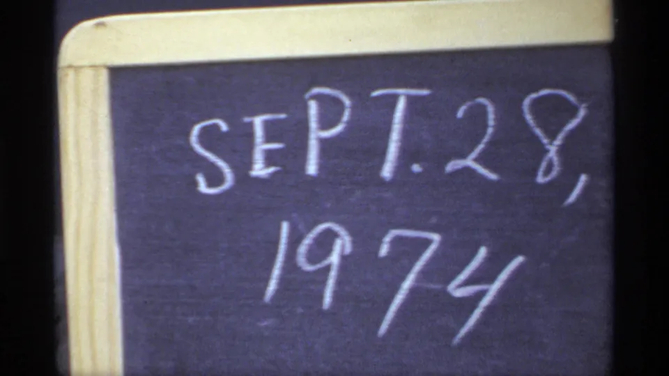 Close-up of a chalkboard date slate reading SEPT. 28, 1974, used to identify the home-movie footage.