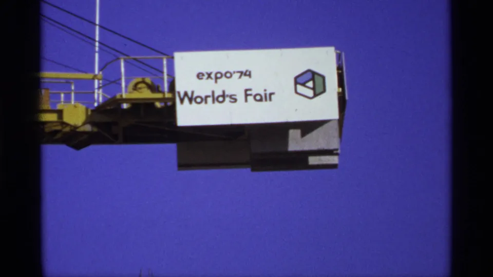 Expo '74 World's Fair signage remains centered, with rails and structural supports visible against the bright Spokane sky.