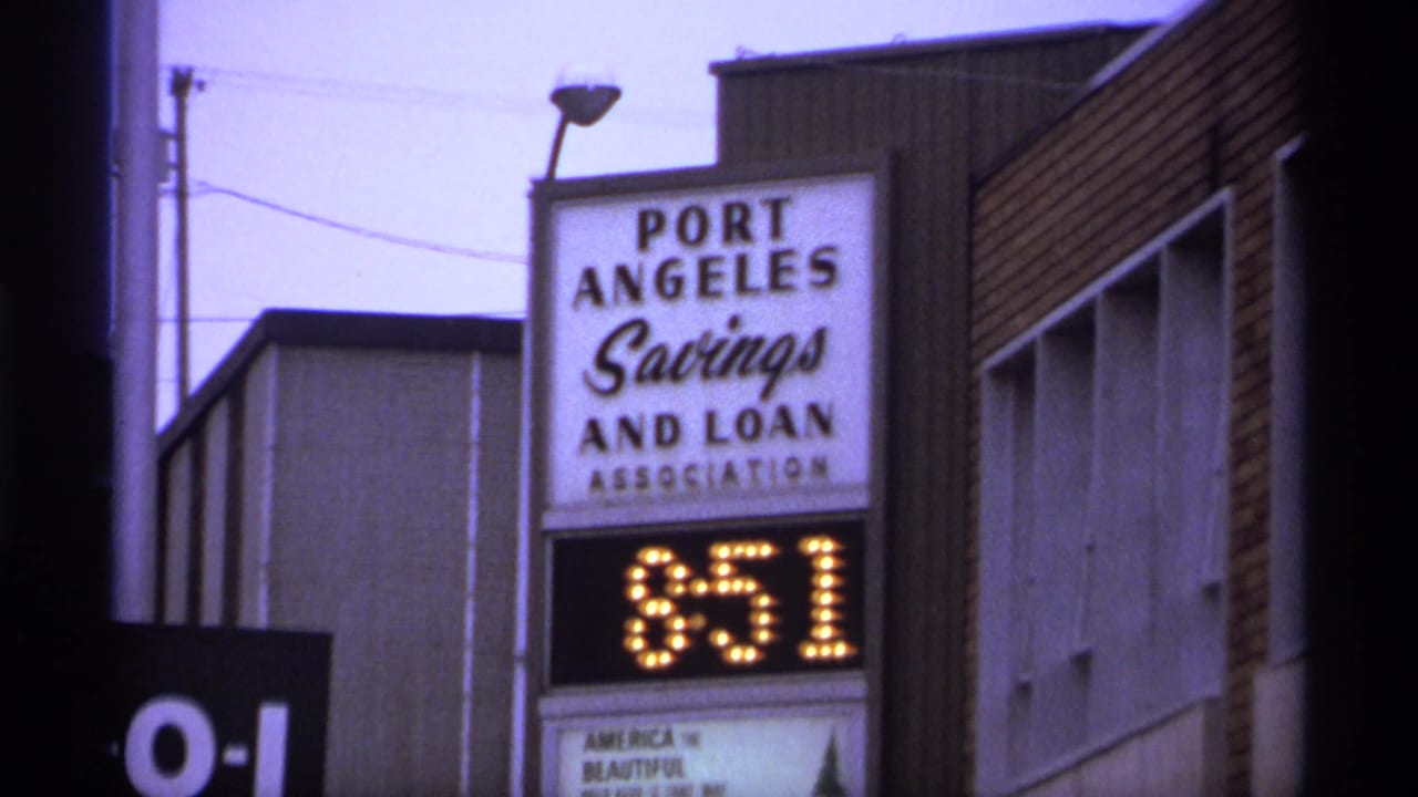 Port Angeles Savings and Loan sign with an 8:51 digital display beside street buildings.