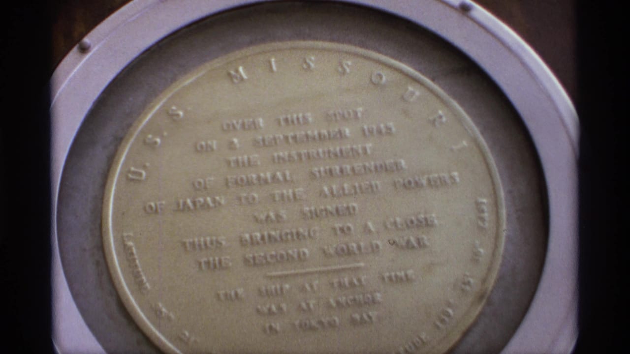 Close view of a round USS Missouri plaque marking Japan's formal surrender.