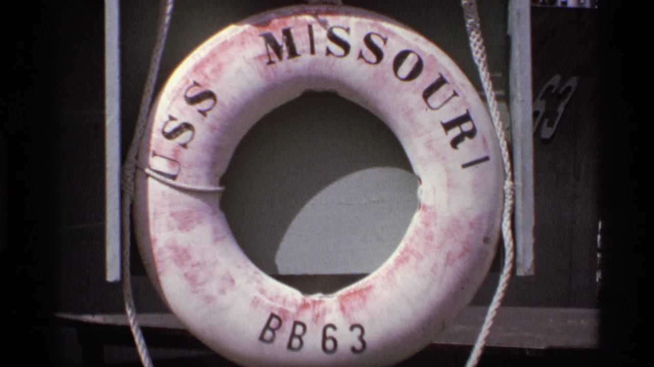 Close view of a USS Missouri BB63 life ring with ropes and dark background.