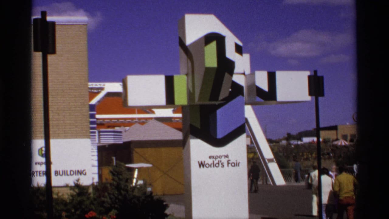 White Expo '74 World's Fair sculpture beside a building and walkway.