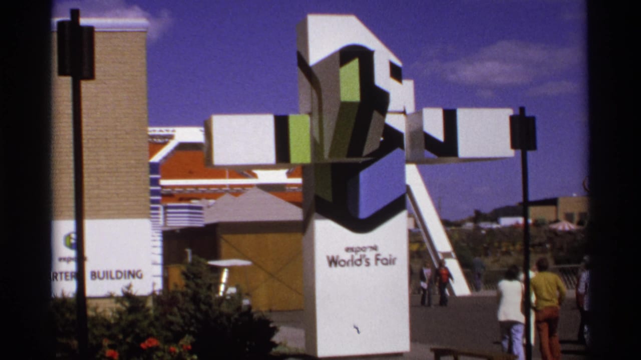 Expo '74 sculpture and fair visitors walking through the grounds.