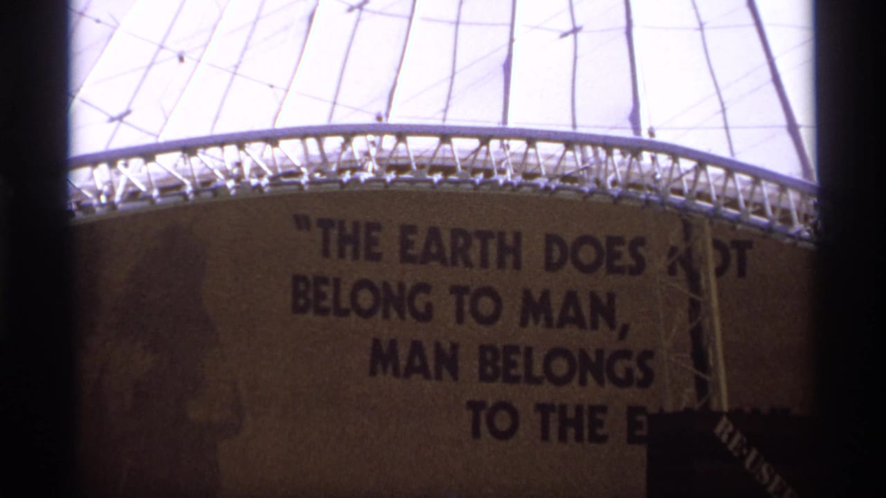 Close view of the dome exterior with a large painted environmental quotation partly visible.