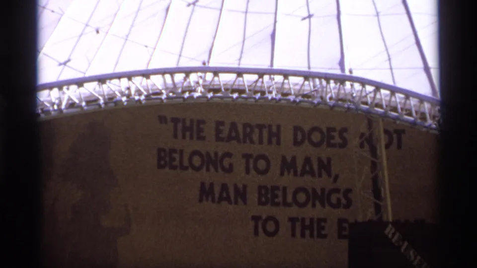 Closer 8mm view of the dome wall and structural rim with the painted quote beginning across the exterior surface.