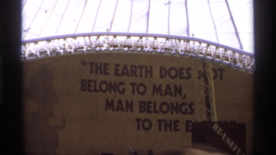 Final close frame holds on the painted environmental quotation, with dome structure and film borders visible.