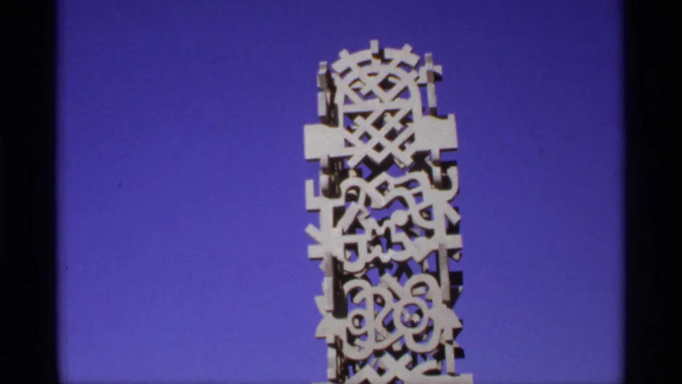 Another close frame of the white patterned architectural feature, with film grain and edge shadow visible.