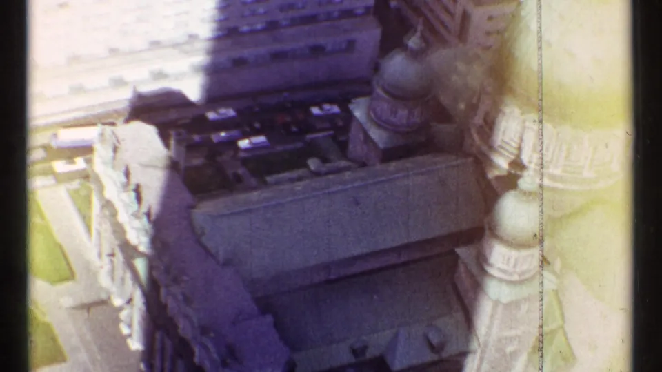 Soft, color-shifted 8mm frame of a Montreal church roofline and domes seen from above in 1967.
