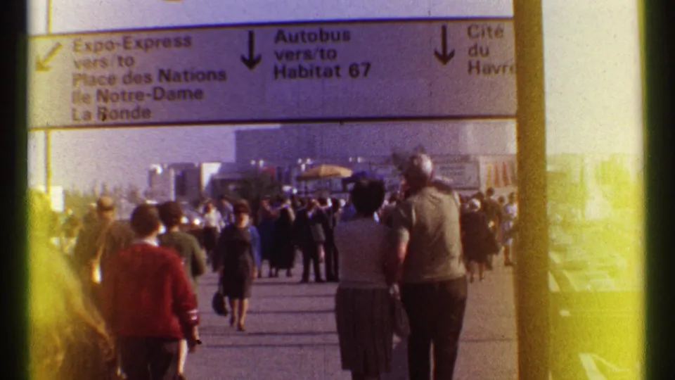 Crowds move through the Montreal Expo 67 grounds beneath directional signage for Expo-Express, Autobus, and other routes.