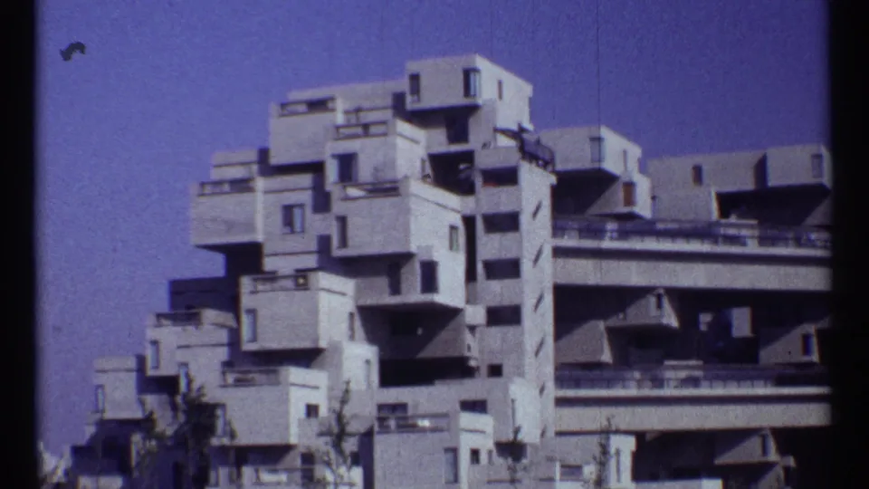 1967 Montreal frame showing Habitat 67's stacked concrete housing modules with balconies and railings visible.