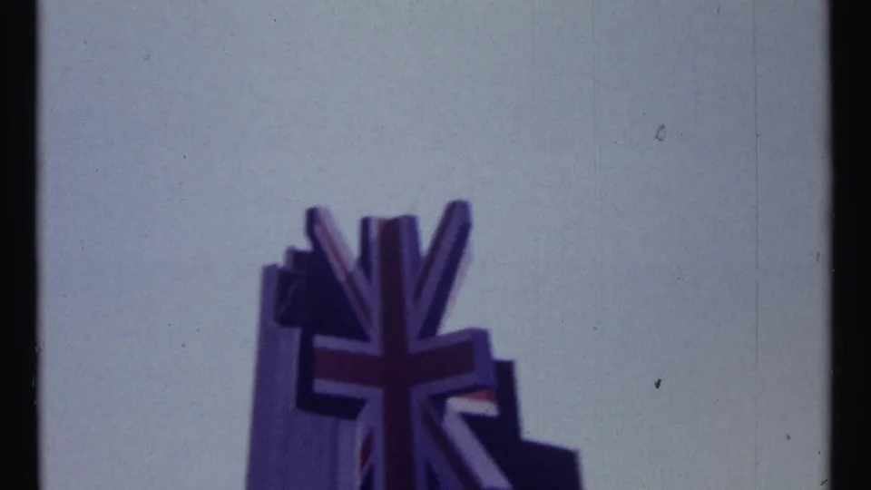 Later frame of the Union Jack-style emblem on the same sculptural structure, filmed softly against a pale sky in Montreal.