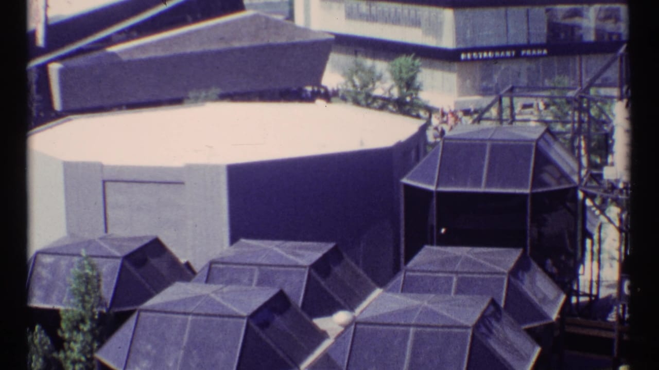 Similar elevated view of fairground roofs, stairs, and pavilion structures.