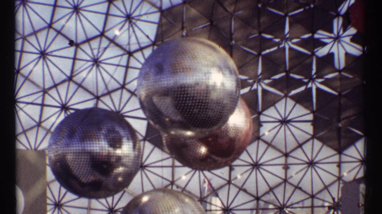 Large mirrored spheres hang against a dome-like metal grid.