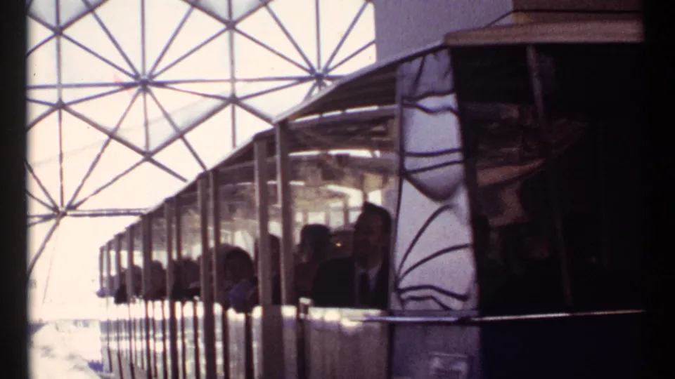 1967 Montreal Expo 67 train car with passengers seen beneath a geometric dome-like roof structure.