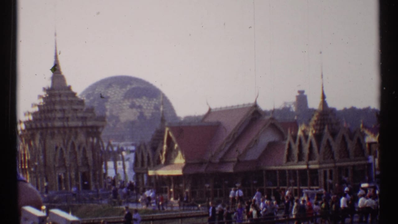 Ornate pavilion buildings with crowds and a geodesic dome in the background.