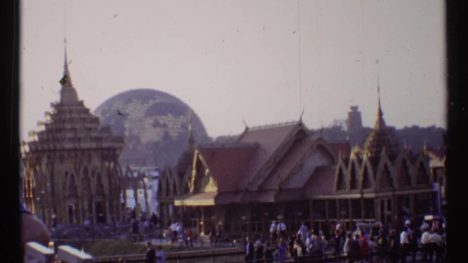 1967 Montreal fairground view with Indian-style pavilion roofs, visitors, and the U.S. Pavilion dome behind them.