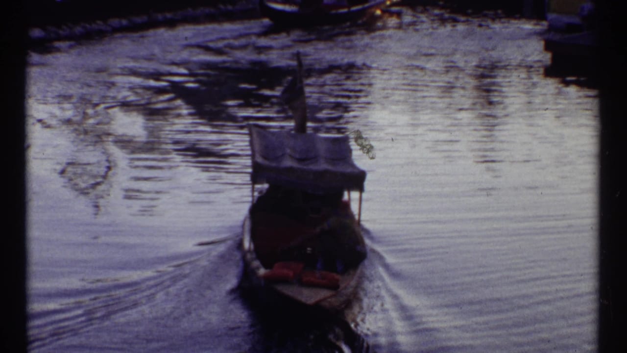 Small boat moving on water with a blue night-frame overlay below.