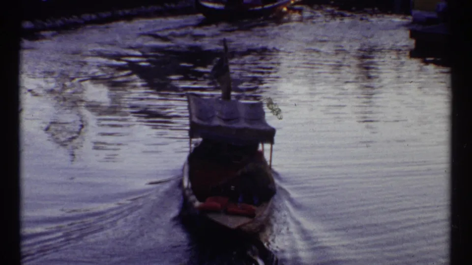 1967 Montreal 8mm frame showing a small boat on rippled water, with part of the contact frame below showing blue night exposure.