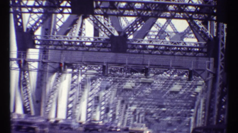 End frame from the 1967 Montreal bridge approach, showing long perspective lines through the Alexandra Bridge steel framework.