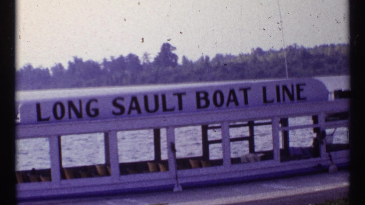 Long Sault Boat Line lettering on a docked passenger boat beside water.