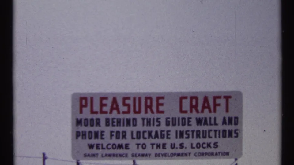 Close 1967 sign instructing pleasure craft to moor behind the guide wall and phone for U.S. Locks lockage instructions.