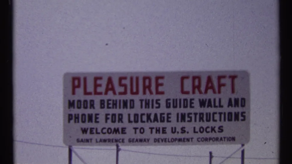 1967 close-up of a U.S. Locks sign welcoming pleasure craft and naming the Saint Lawrence Seaway Development Corporation.