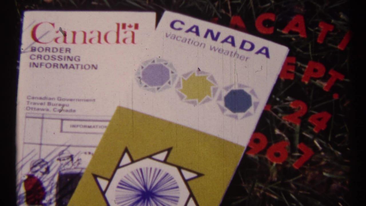 Close 8mm frame of Canada border crossing information and vacation weather brochures, with red 1967 date text partly visible.