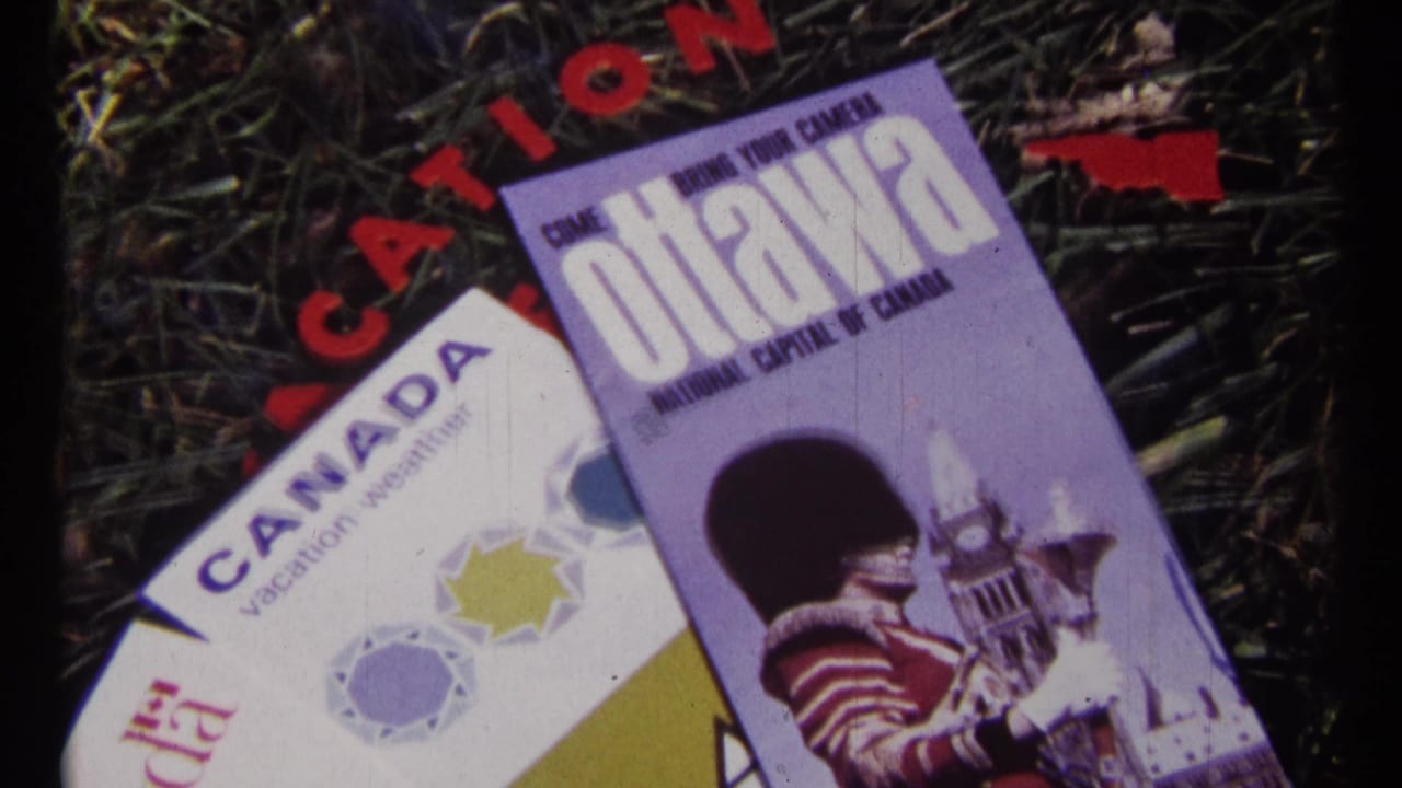 Canadian travel brochures lying on grass, including Canada and Ottawa printed material.