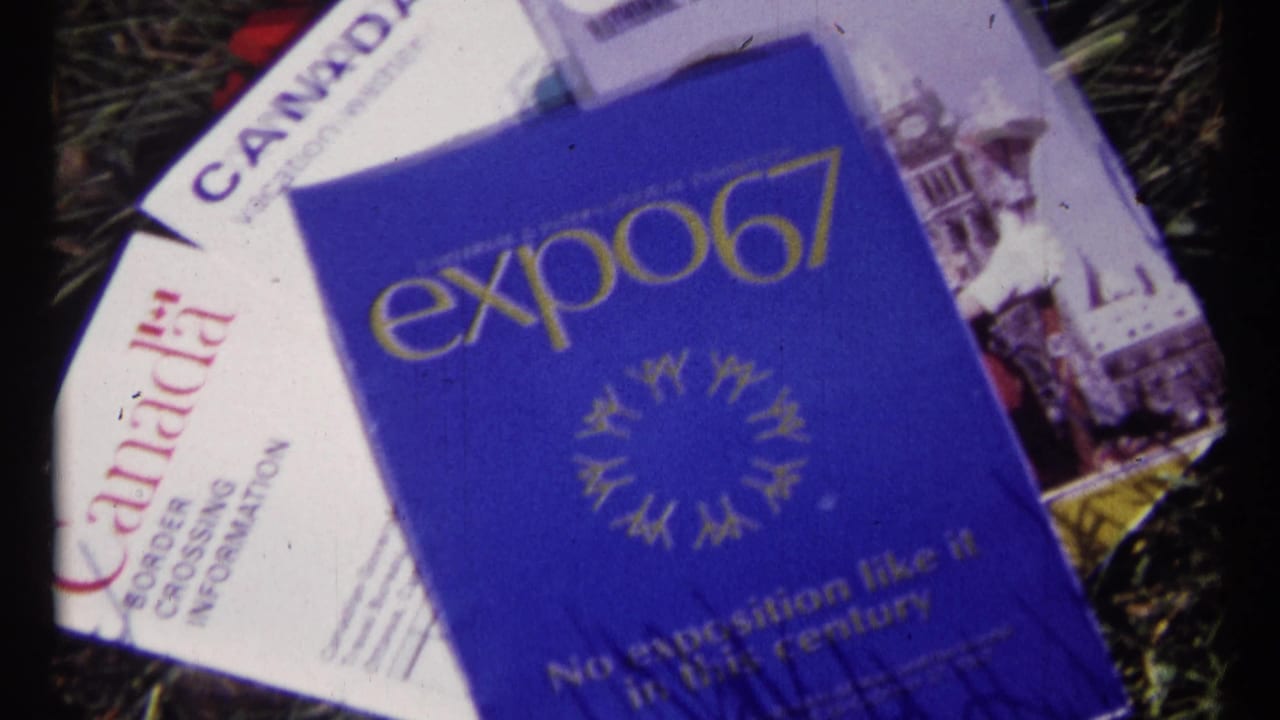 Expo 67 brochure on top of Canada travel papers with grass visible around the edges.