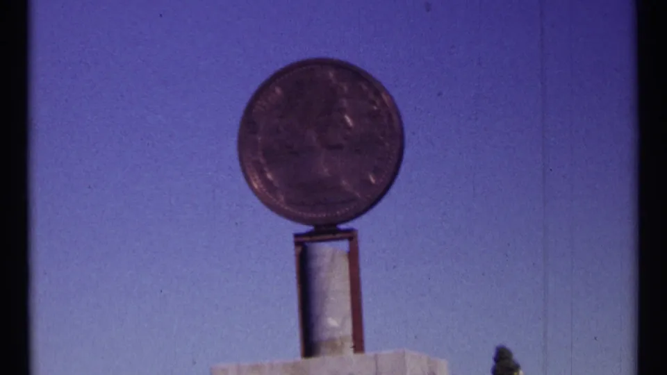1967 Ottawa 8mm frame with a round coin display centered above its support, recorded from a visitor viewpoint.