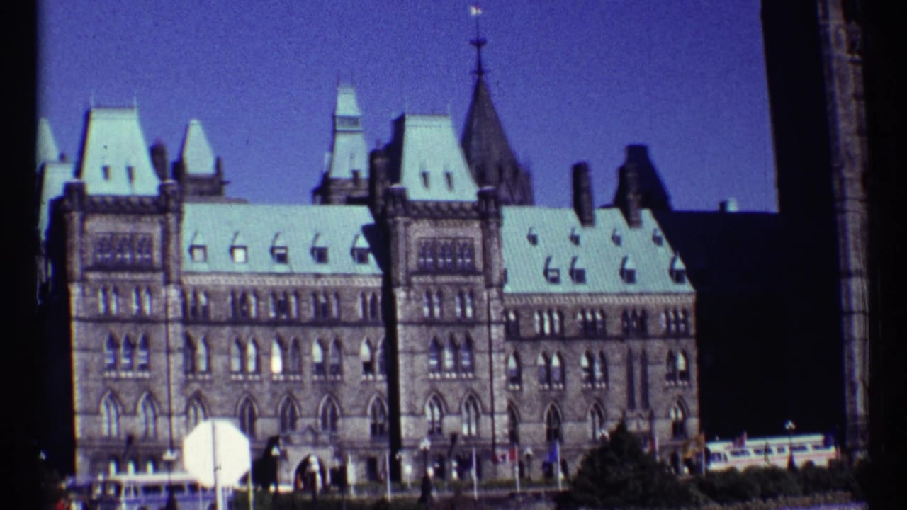 Ottawa Parliament building exterior with pale roof and tower forms.