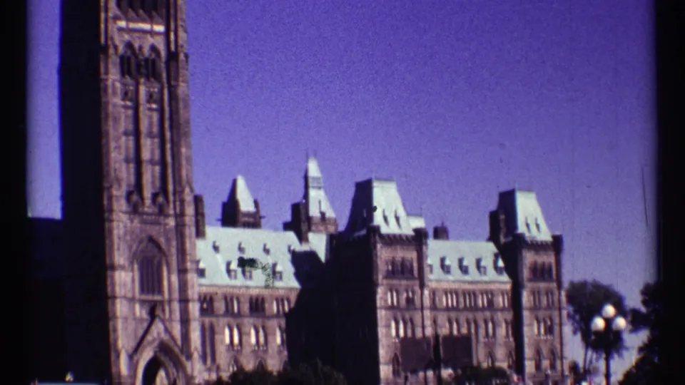 1967 Ottawa home-movie frame showing Parliament Buildings and part of the Peace Tower with soft 8mm color shift.