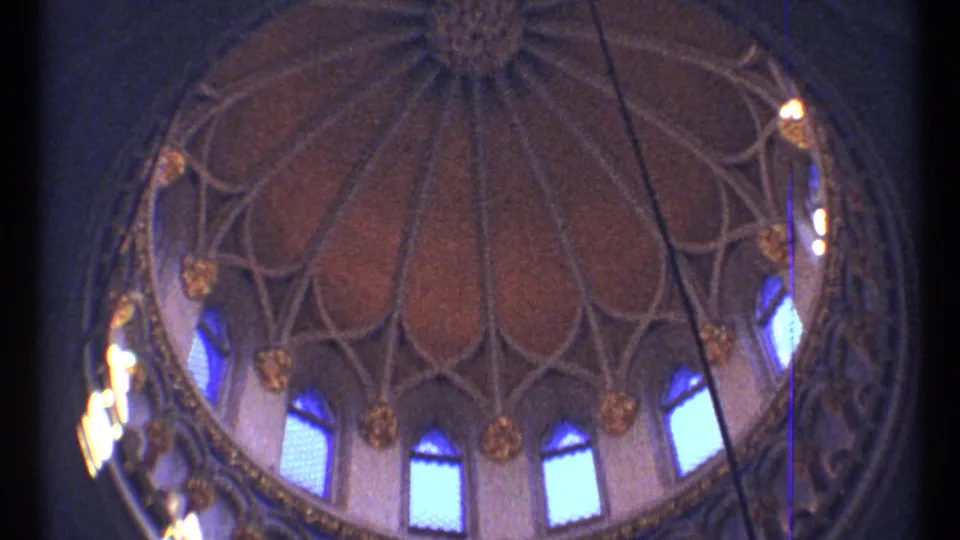 1967 Ottawa 8mm frame showing an ornate interior dome with ribbed vaulting, blue arched windows, and decorative gold details.