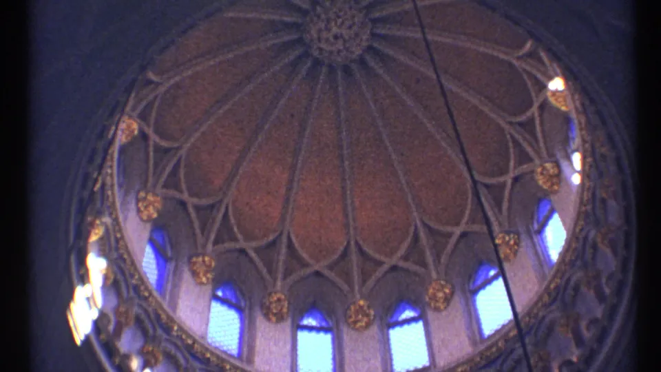 1967 Ottawa 8mm frame of a vaulted dome interior, showing repeating ribs, blue arched windows, gold ornament, and soft handheld framing.