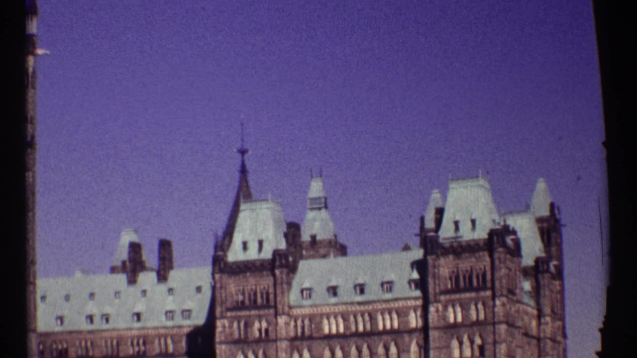 Similar view of Parliament towers and roofline beneath a tinted sky.